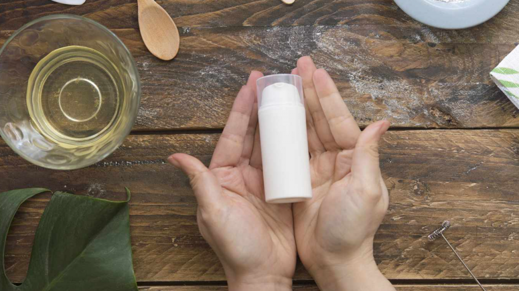 Women hands carrying glass bottle representing home made products business for women