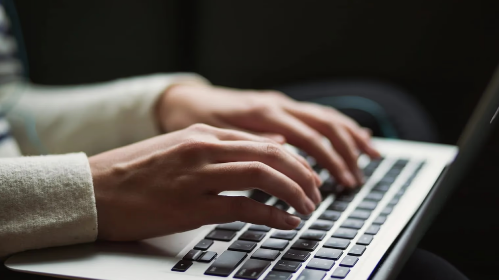 Women typing on laptop representing online marketing business for women