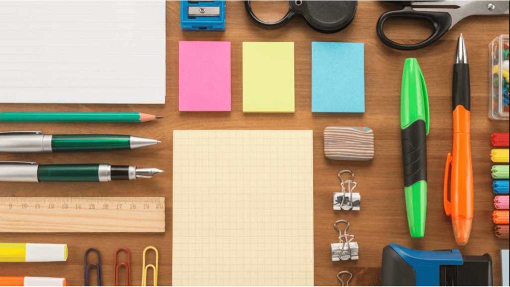 Wholesale office essentials including pens, notepads, a stapler, and a desk organizer ready for use