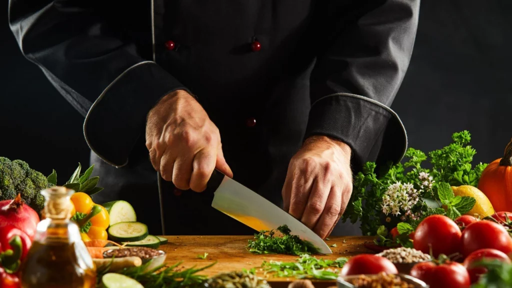 A chef cutting vegetables. 